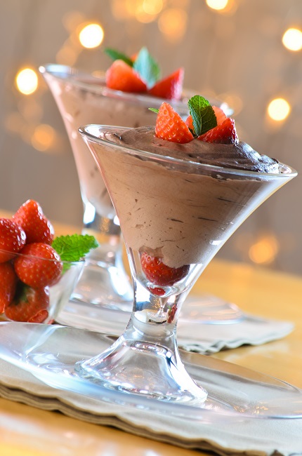 Cup with chocolate mousse dessert with strawberry and mint leaf